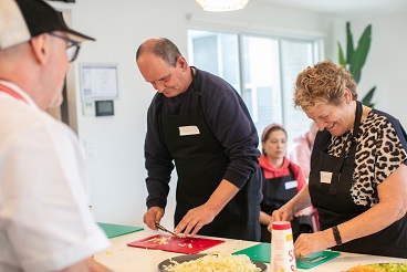 Two people cooking in the kitchen