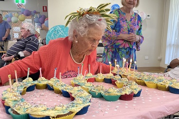 Lillian blowing out her 100th birthday candles