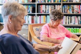 Two elderly females reading peacefully  Two elderly females reading peacefully