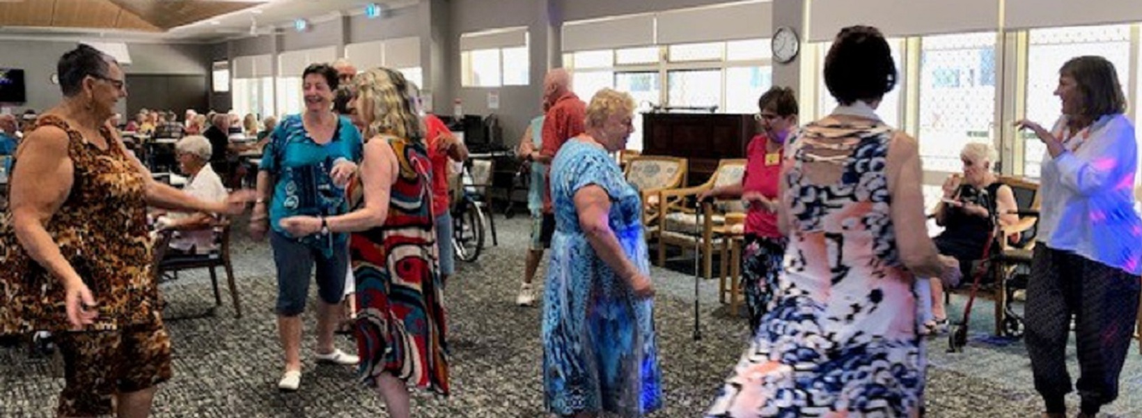 A group of retirement village residents dancing A group of retirement village residents dancing