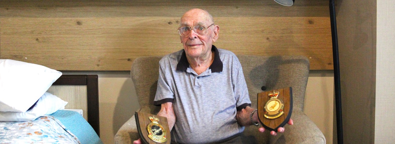 Lewis with his awarded service plaques.jpg Lewis with his awarded service plaques.jpg